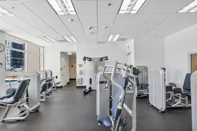 a gym with rows of cardio equipment in a room at Ocean front private unit in Miami