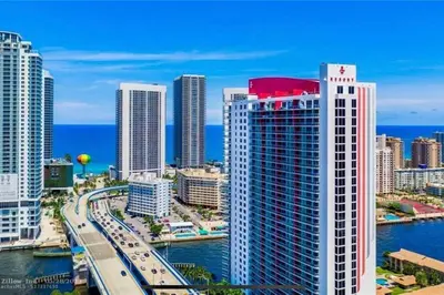 a view of a city with buildings and the ocean at Sunny Studio Stay, 2 Full Beds, Coastal Walks Nearby in Hallandale Beach
