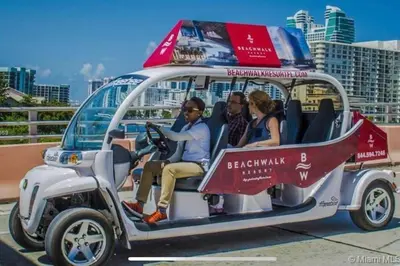 a group of people sitting in a golf cart at Sunny Studio Stay, 2 Full Beds, Coastal Walks Nearby in Hallandale Beach