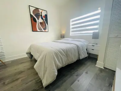 a bedroom with a bed and a painting on the wall at Alma Guest Suite in Miami