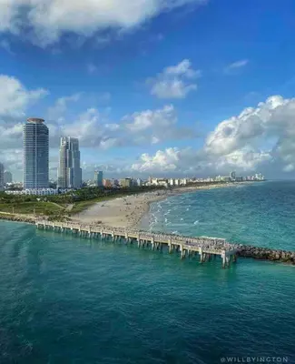 a pier in the ocean next to a beach at Alma Guest Suite in Miami