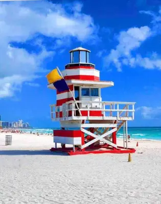 a red white and blue lighthouse on the beach at Alma Guest Suite in Miami
