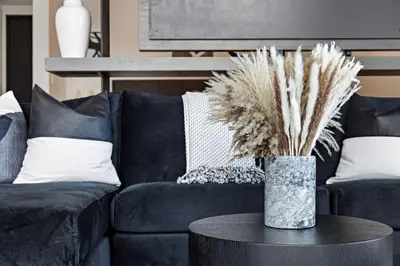 a living room with a blue couch and a table at Corner condo w/ Unrivaled views in Miami