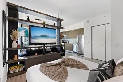 a living room with a large flat screen tv at Corner condo w/ Unrivaled views in Miami