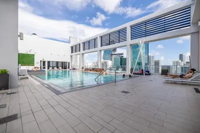 a swimming pool on the roof of a building at Cozy Downtown Pad- Luxe Rooftop pool gym and more in Miami