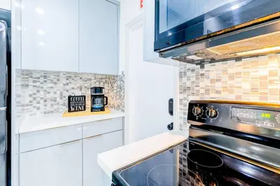 a kitchen with white cabinets and an oven at Angies-10 Min Beach-10 People-Terrace-Families in Hollywood