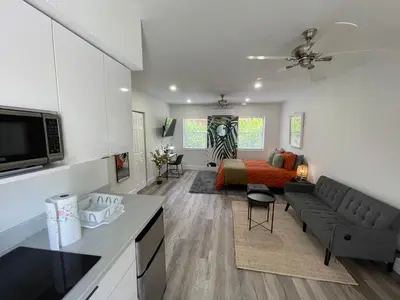 a living room with a couch and a bed at Casa Habana Studios in Miami
