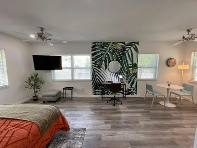 a bedroom with a bed and a table and chairs at Casa Habana Studios in Miami