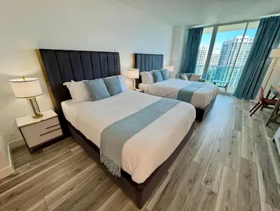 a hotel room with two beds and a large window at Balcony Ocean View ! WiFi - Pool - Gym - Parking in Miami