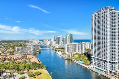 an aerial view of a city with a river and buildings at Water View Building With Pool - 5-Min Walk To The Beach - Cozy Studios in Hallandale Beach