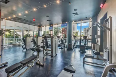 a gym with treadmills and cardio equipment in a building at Water View Building With Pool - 5-Min Walk To The Beach - Cozy Studios in Hallandale Beach