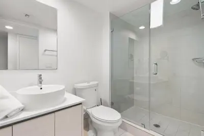a white bathroom with a toilet and a shower at Water View Building With Pool - 5-Min Walk To The Beach - Cozy Studios in Hallandale Beach