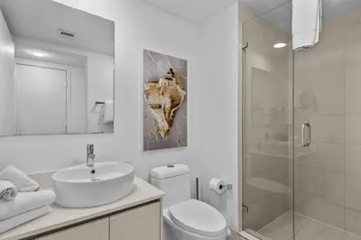 a bathroom with a sink and a toilet and a shower at Water View Building With Pool - 5-Min Walk To The Beach - Cozy Studios in Hallandale Beach