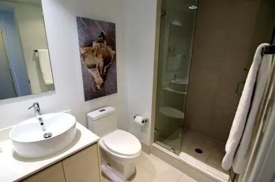 a bathroom with a toilet and a sink and a shower at Hallandale Beach, Pool, Gym & More in Hallandale Beach