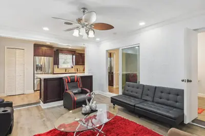 a living room with a couch and a table at Patio and Yard Family-Friendly Miami Oasis! in Miami Gardens