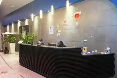 a man sitting at a counter in a restaurant at 2BR Luxury Stay, Pool, Beach & Mall in Hallandale Beach