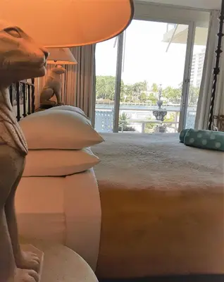 a bedroom with a bed with a lamp on it at Manhattan Tower Apartment Hotel in Fort Lauderdale