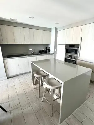 a kitchen with a table and two stools at Luxury 2 bedroom with ocean view in Hollywood