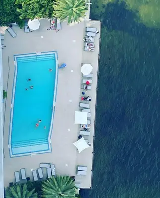 an overhead view of a swimming pool next to the water at 2 Full Bed BeachWalk Studio, Ocean Nearby, Feels Like Home in Hallandale Beach