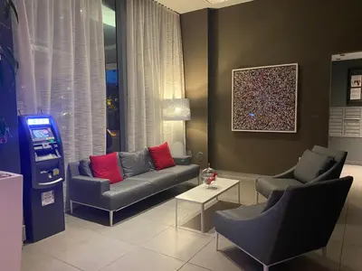 a living room with a couch and two chairs at Modern Studio Escape at BeachWalk, Perfect for Small Groups -B in Hallandale Beach