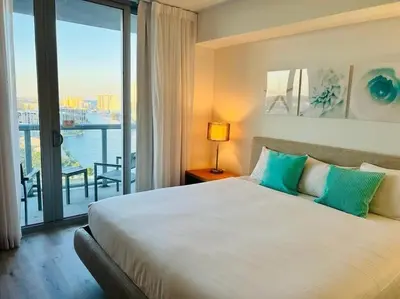 a bedroom with a large bed and a large window at Sophisticated Beach Escape, Breathtaking Views & Comfort -2A in Hallandale Beach