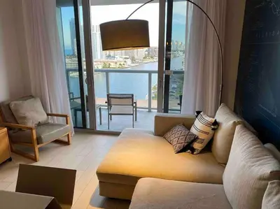 a living room with a couch and a large window at Relax in Style, Miami Beach Apt with Full Kitchen and Dreamy Views -A in Hallandale Beach