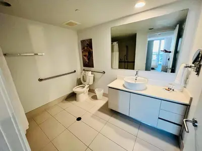 a bathroom with a sink and a toilet and a mirror at Relax in Style, Miami Beach Apt with Full Kitchen and Dreamy Views -A in Hallandale Beach