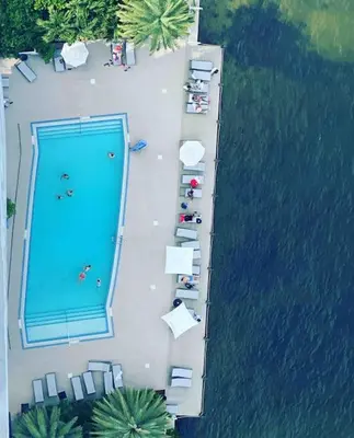 an overhead view of a swimming pool next to a lake at Cozy Beach Apartment, Full Kitchen & Ocean Views -A in Hallandale Beach