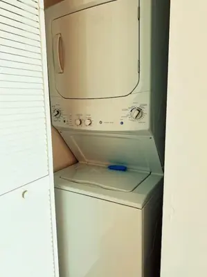 a microwave sitting on top of a white refrigerator at Stylish Beach Condo with Full Kitchen -A in Hallandale Beach