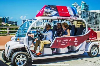 a group of people sitting in a golf cart at Walk to the Beach, Sleep in Comfort, Studio for 4 in Hallandale Beach