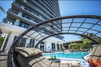a resort with a swimming pool and a building at Walk to the Beach, Sleep in Comfort, Studio for 4 in Hallandale Beach