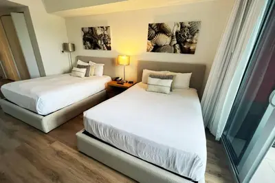 a hotel room with two beds and a window at Chill Out in This Stylish 2-Full Bed BeachWalk Studio in Hallandale Beach