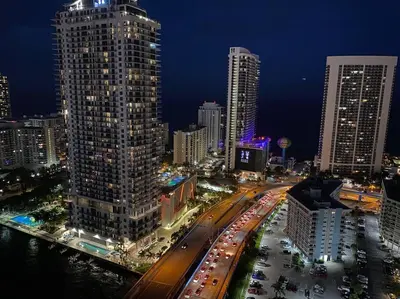 a city skyline with tall buildings and traffic at night at Studio with 2 Full Beds, Your Beach Base in the City in Hallandale Beach