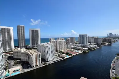 an aerial view of a city with a river and buildings at Cozy BeachWalk Nest, 2 Full Beds, Steps to Ocean in Hallandale Beach