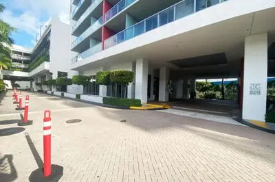 a building with red and white cones in front of it at Sunlit BeachWalk Studio, 2 Full Beds, Coastal Charm in Hallandale Beach