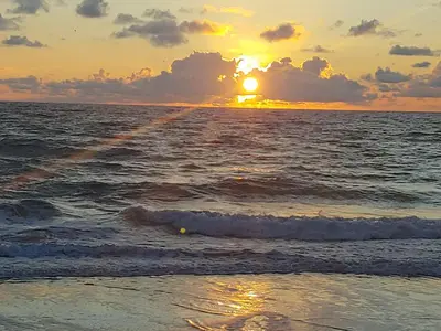 a sunset on the beach with the ocean at Stylish 2BR Villa full kitchen 10 mins from Beach in Fort Lauderdale