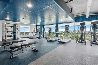 a gym with treadmills and machines in a building at Aloft Fort Lauderdale Airport & Cruise Port in Fort Lauderdale