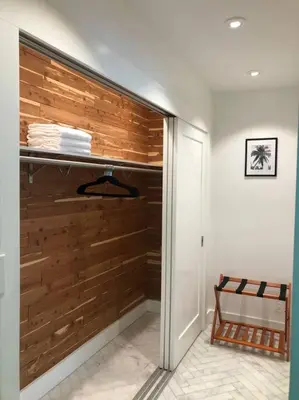a walk in closet with a wooden wall at Villa Palma-Hollywood Beach-Private Pool & Beachwalk! in Hollywood