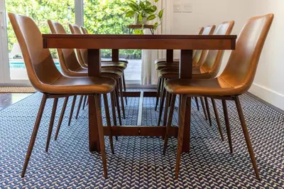 a wooden table with leather chairs around it at Villa Palma-Hollywood Beach-Private Pool & Beachwalk! in Hollywood