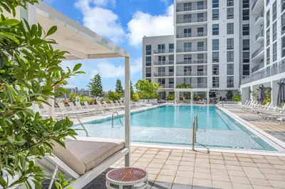 a swimming pool with lounge chairs and a building at Modern Unit in Downtown Miami With Free Parking in Miami