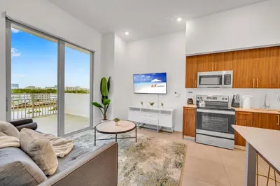 a living room with a couch and a kitchen at Modern Unit in Downtown Miami With Free Parking in Miami