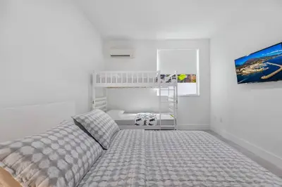 a bedroom with a bed and a bunk bed at Up to 16 guests! Modern house near Wynwood in Miami
