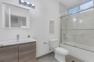 a bathroom with a toilet and a shower and a sink at Up to 16 guests! Modern house near Wynwood in Miami