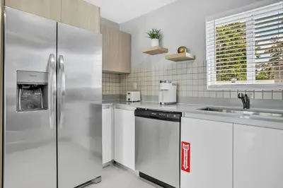 a kitchen with a stainless steel refrigerator and a sink at Sistrunk Shades Villas #2 New Downtown Fort Lauderdale Townhomes in Fort Lauderdale
