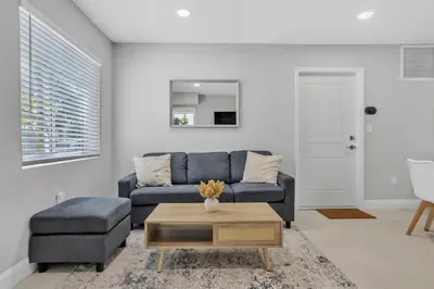 a living room with a blue couch and a table at 30 Guests 3 Identical Brand New Townhomes in Downtown Fort Lauderdale in Fort Lauderdale