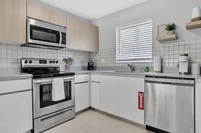 a kitchen with white cabinets and a stove top oven at 30 Guests 3 Identical Brand New Townhomes in Downtown Fort Lauderdale in Fort Lauderdale