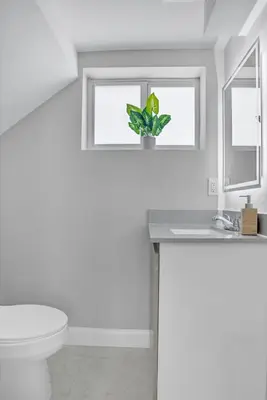 a bathroom with a toilet and a sink and a window at 30 Guests 3 Identical Brand New Townhomes in Downtown Fort Lauderdale in Fort Lauderdale