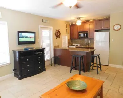 a living room with a kitchen with a table and a tv at 310 Oasis Paradise in Hollywood
