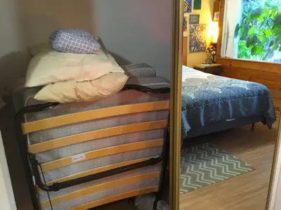 a mirror reflection of a bed in a bedroom at Miami Bungalow Oasis near Everglades & The Keys in Cutler Bay