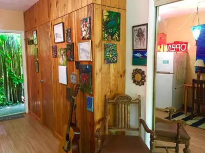 a room with a guitar and a chair in a room at Miami Bungalow Oasis near Everglades & The Keys in Cutler Bay